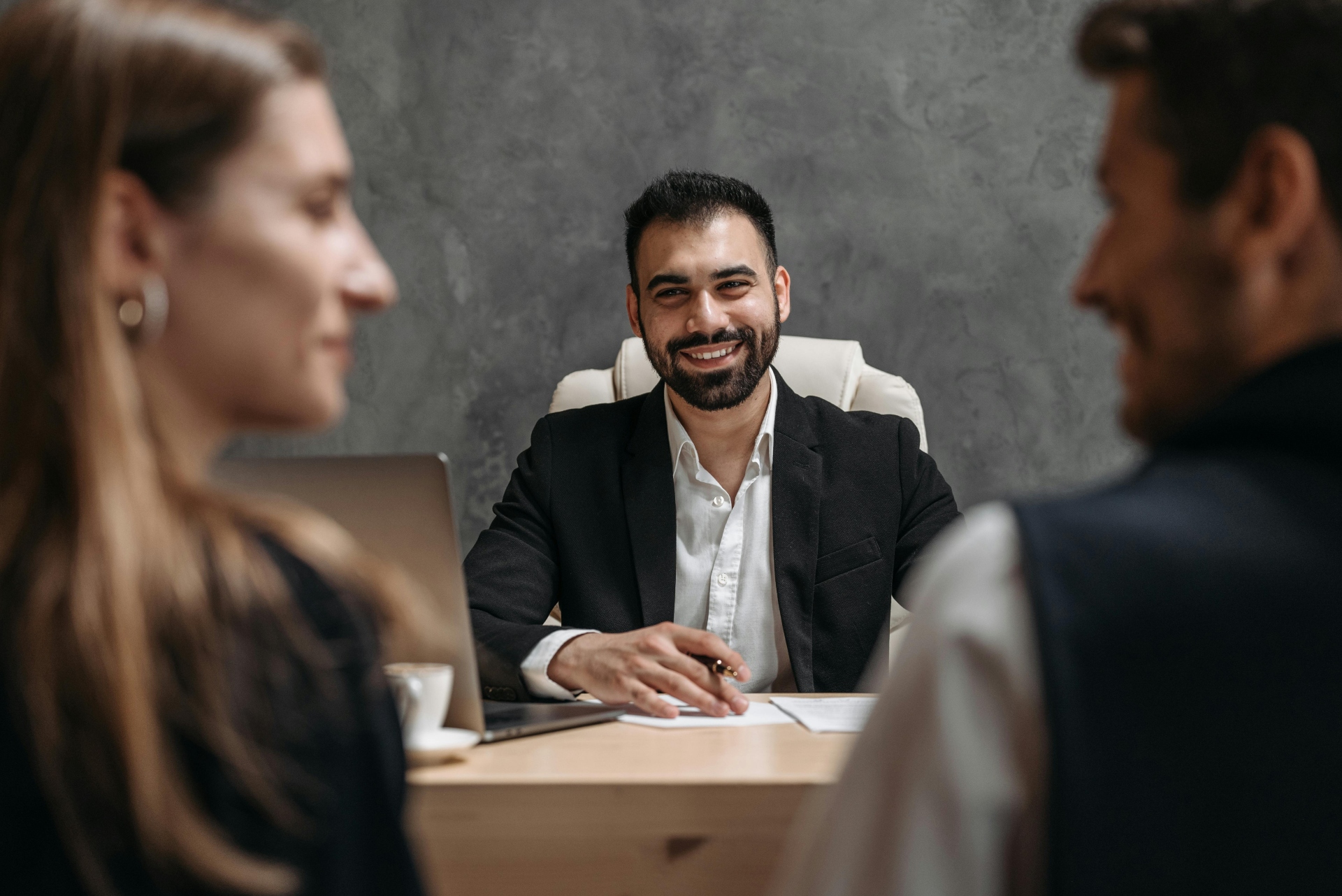 3 business associates talking looking satisfied